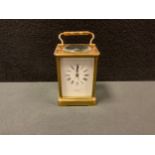 A French brass carriage clock, the white dial, signed W Bell, Lancaster, with bold Roman numerals,