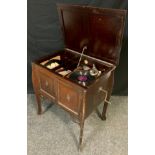 A Gilbert ‘Geisha’ mahogany cabinet gramophone, with a small quantity of early 20th century records.