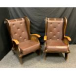 A pair of 20th century elm wing back arm chairs, pegged construction, removeable brown back