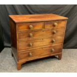 A George III mahogany chest of two short over three long graduated drawers, later brass handles, bra
