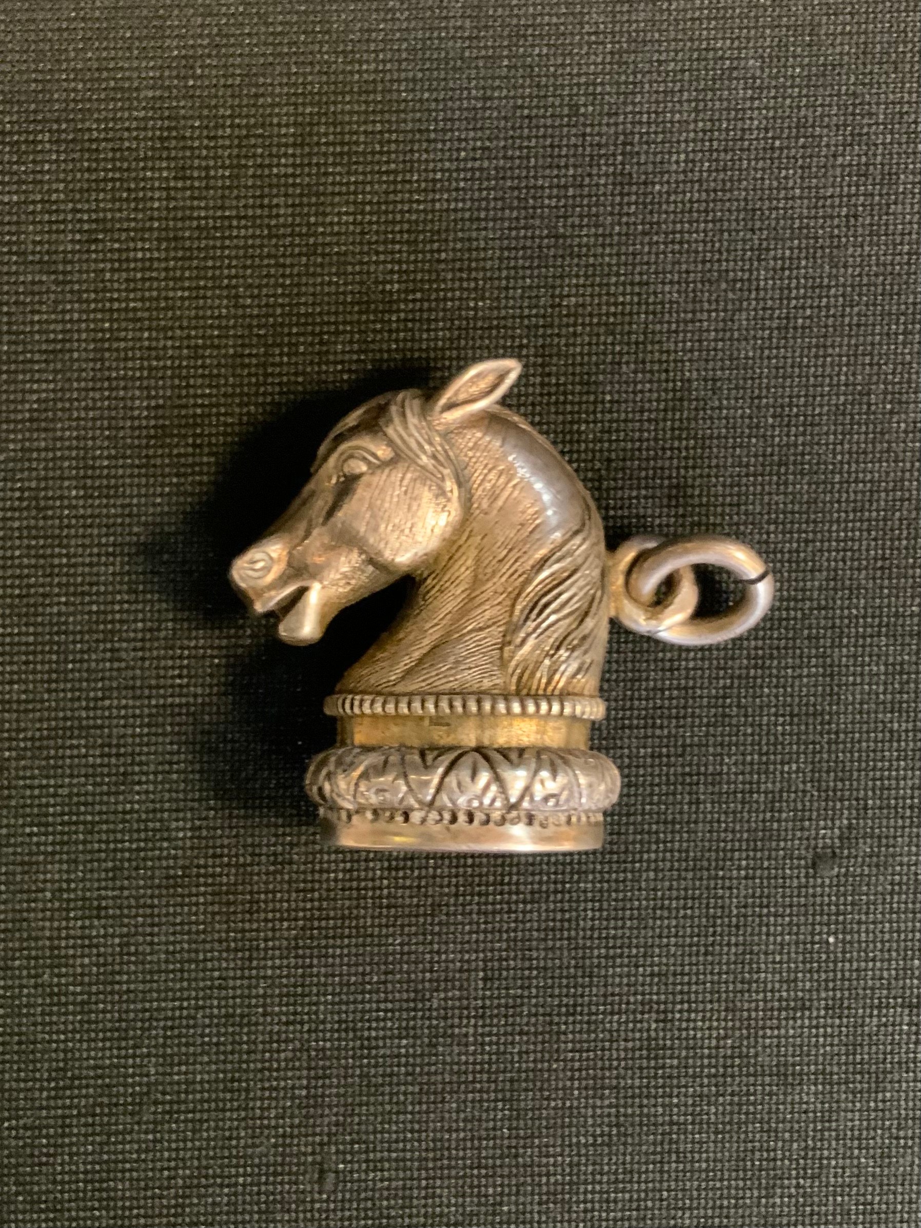 A novelty silver coloured metal and carnelian Horse head seal stamp, plain matrix, 2.7cm high