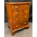 A 20th century George III style, burr walnut, reproduction narrow chest of drawers, over-sailing