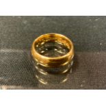 A 22ct gold wedding band, size L/M, 9.6g
