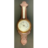 An Art Nouveau carved cased aneroid Barometer Thermometer, 84cm high