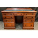 A late Victorian mahogany knee-hole desk, blue leather inset top, small central drawer to frieze