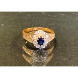 A sapphire and diamond oval cluster ring, central oval blue sapphire approx 0.20ct, above a