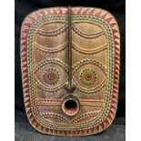 A large Tribal African style carved and painted wood mask, 77cm x 58.5cm.