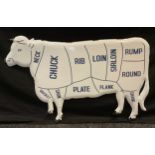 A reproduction butcher’s enamelled sign of a cow showing the cuts of meat, 52cm tall x 82cm long.