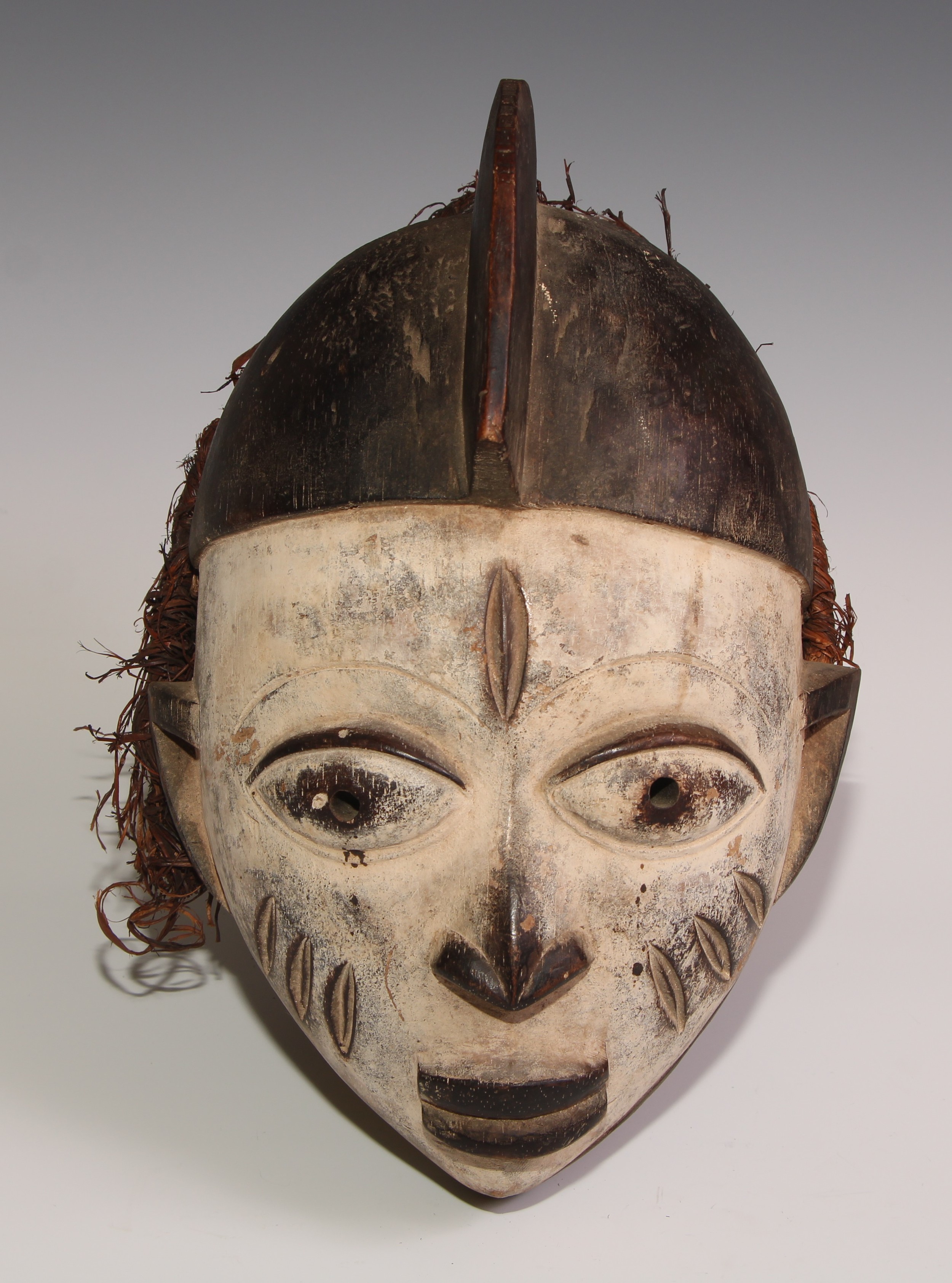 Decorative Tribal Art and the Eclectic Interior - a Baule mask, lofty stylised coiffure, scarified - Image 2 of 3