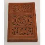 A 19th century Indian sandalwood rectangular visiting card case, pierced and carved with a bird