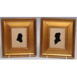 A pair of early 20th century reverse painted glass silhouettes, a lady and gentleman, bust length to