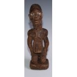 Tribal Art - a Kongo power figure (nkondo nkisi), the fetish figure kneels, the chin and cheeks