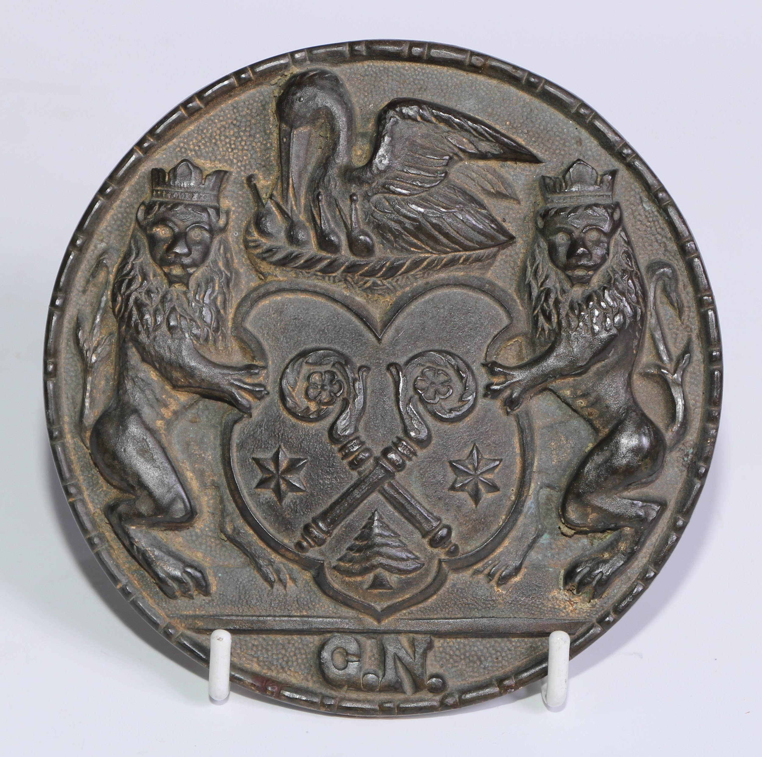 Heraldry - a 19th century bronze armorial boss, cast in relief with a coat of arms comprising