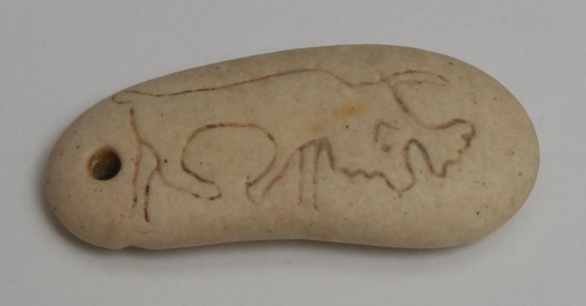 Antiquities - a double-sided stone Scythian animal amulet, depicting an elk and a lion, 4.5cm