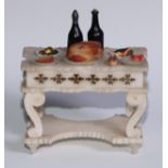 A French alabaster table, carved and painted as a table laden with food, 13cm wide, c.1880