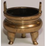 A Chinese bronze ding tripod censer, angular lug handles, 8.5cm wide