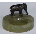 An Austrian cold painted bronze, of an elephant, mounted on a green onyx dish, 9.5cm diam, c.1930