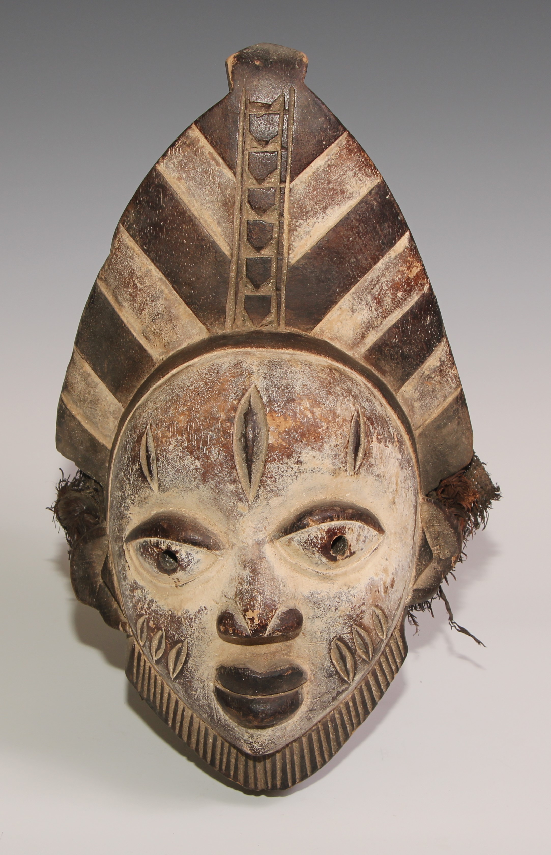 Decorative Tribal Art and the Eclectic Interior - a Baule mask, lofty stylised coiffure, scarified - Image 3 of 3