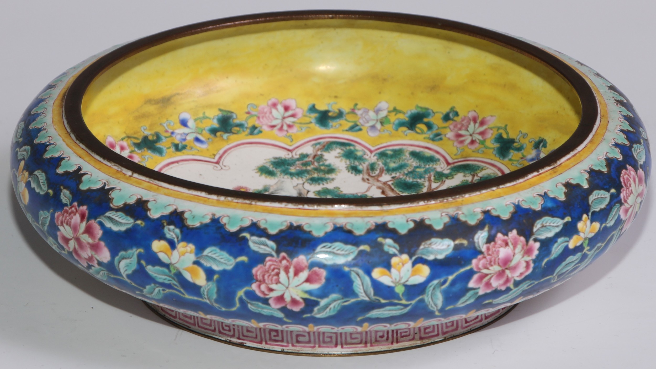 A Chinese famille rose enamel bowed circular bowl, painted in the typical Cantonese manner with