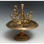 An unusual early 20th century brass table top model merry-go-round, modelled with four children on