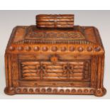 An unusual hardwood rectangular cigar box, carved and surmounted with bundles of cigars, 30cm