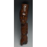 A 19th century folk art walking stick handle, carved with Ottoman heads, 20cm long