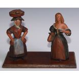 Folk Art - a carved and polychrome painted novelty bookslide, the end supports carved as figures