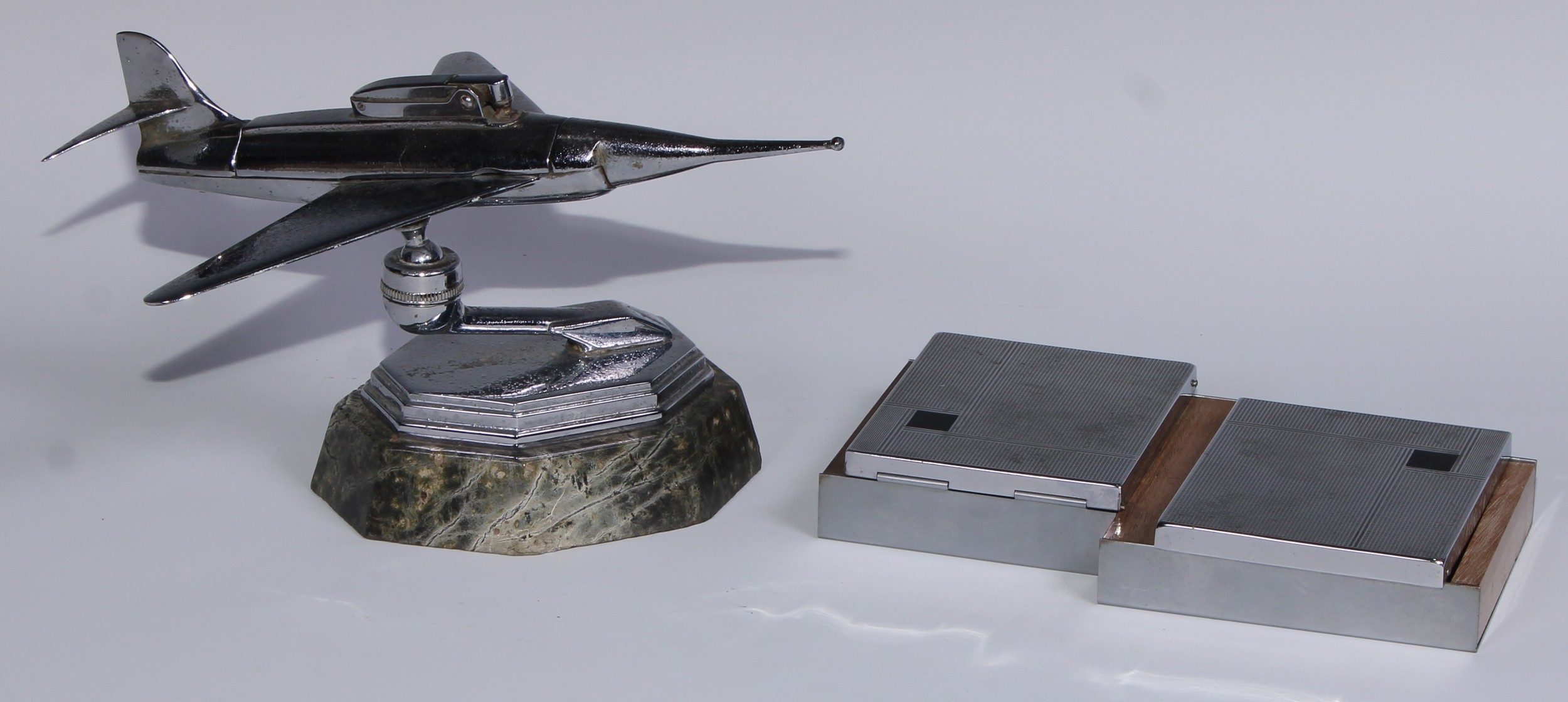 A mid-20th century chrome table lighter, as a fighter jet, marble base, 24cm long; an Art Deco style