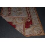 An Aubusson style hand woven rug, woven with stylised flowers, 184cm x 118cm