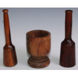 Treen - a 19th century lignum vitae pestle, 27cm long; another pestle; a turned lignum vitae mortar,