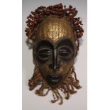 Decorative Tribal Art and the Eclectic Interior - a West African mask, stylised eliptical