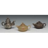 A Chinese green stone teapot, carved with verse picked out in green and red, 14.5cm long; another,