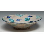 A Middle Eastern tin glazed bowl, decorated in the Islamic Persian manner with stylised organic