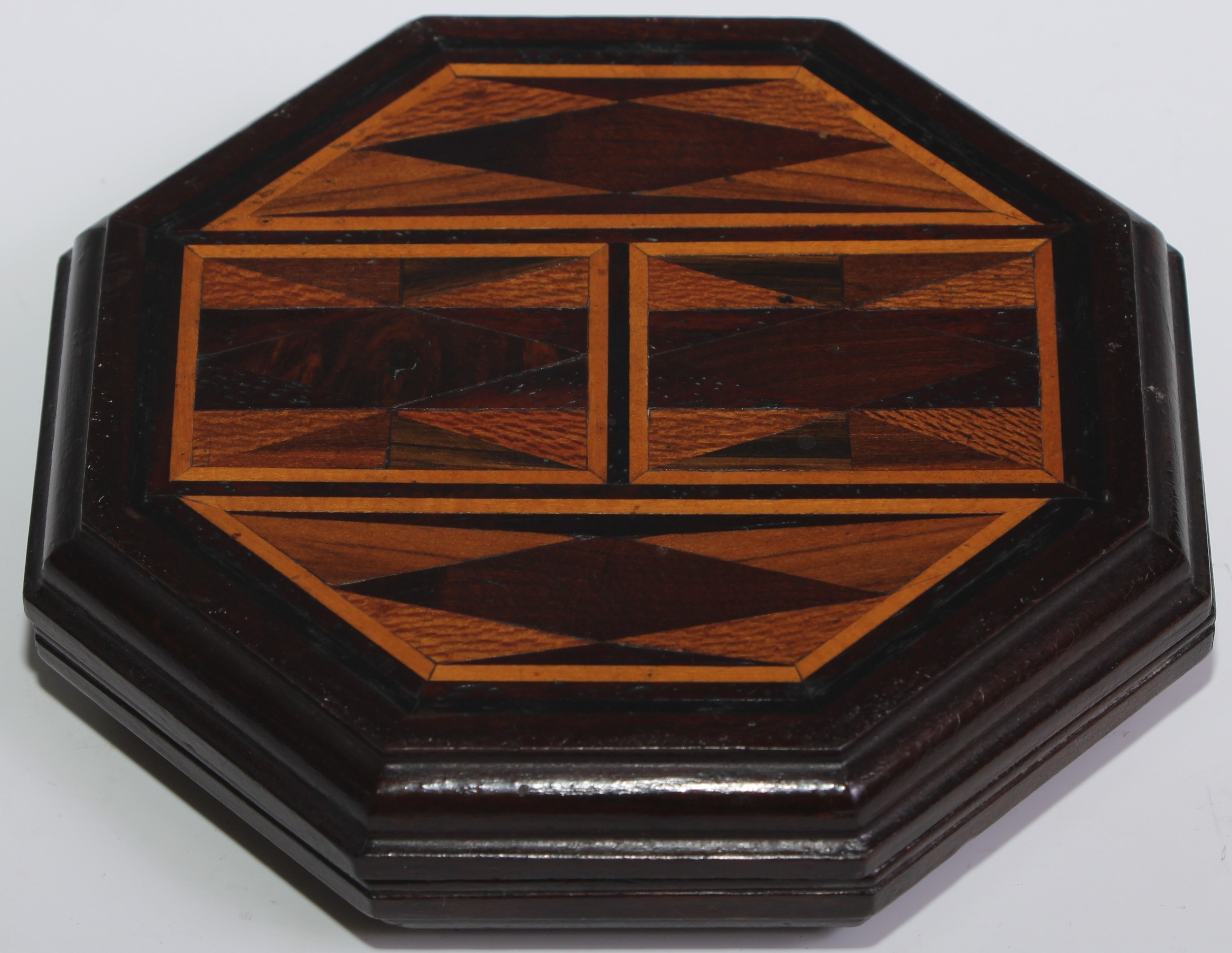A specimen timber sample, inlaid with a geometric field of cedar, carob, mulberry, oak, acacia,