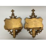 A pair of Gothic Revival giltwood folding wall brackets, carved and pierced with tracery, the