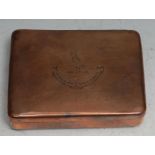 A 19th century copper rounded rectangular tobacco box, hinged cover crested and with motto In