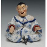 A German porcelain nodding pagoda figure, modelled as a Chinese lady, seated cross-legged, 14cm