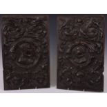 A pair of 16th century oak Romayne panels, carved in relief with profile portraits, bust-length,