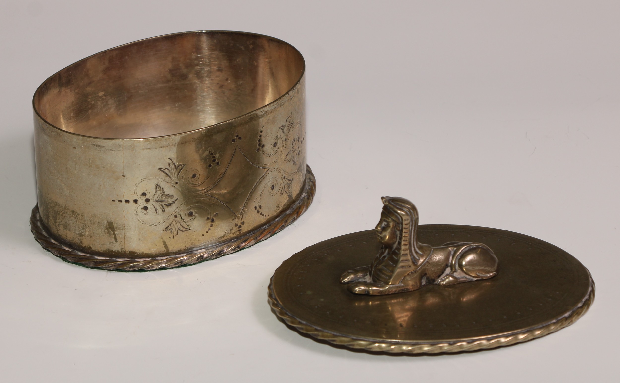 A Victorian Egyptian Revival silver plated oval box and cover, bright-cut engraved and surmounted by - Image 3 of 5
