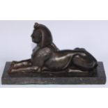 A 19th century library model, cast as a sphinx, rectangular marble base, 28cm long