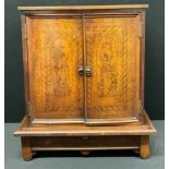 A North Italian cedar and penwork collector's cabinet on stand, hinged top above a pair of drawers