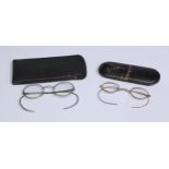 A pair of late 19th century 14k gold spectacles, 10.5cm wide, marked under nose bridge, cased; a