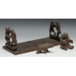 A Black Forest carved wooden book slide, the ends carved with two fighting bears, 34cm closed, c.