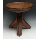 Tribal Art - an Igbo stool, dished circular top above three outswept legs carved with geometric