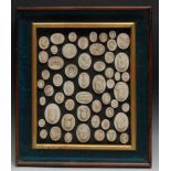 An arrangement of plaster intaglio impressions, mostly Grand Tour subjects, framed, 37cm x 32cm