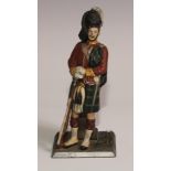 An Austrian cold painted novelty table lighter, as a Scottish Highland soldier, in full dress