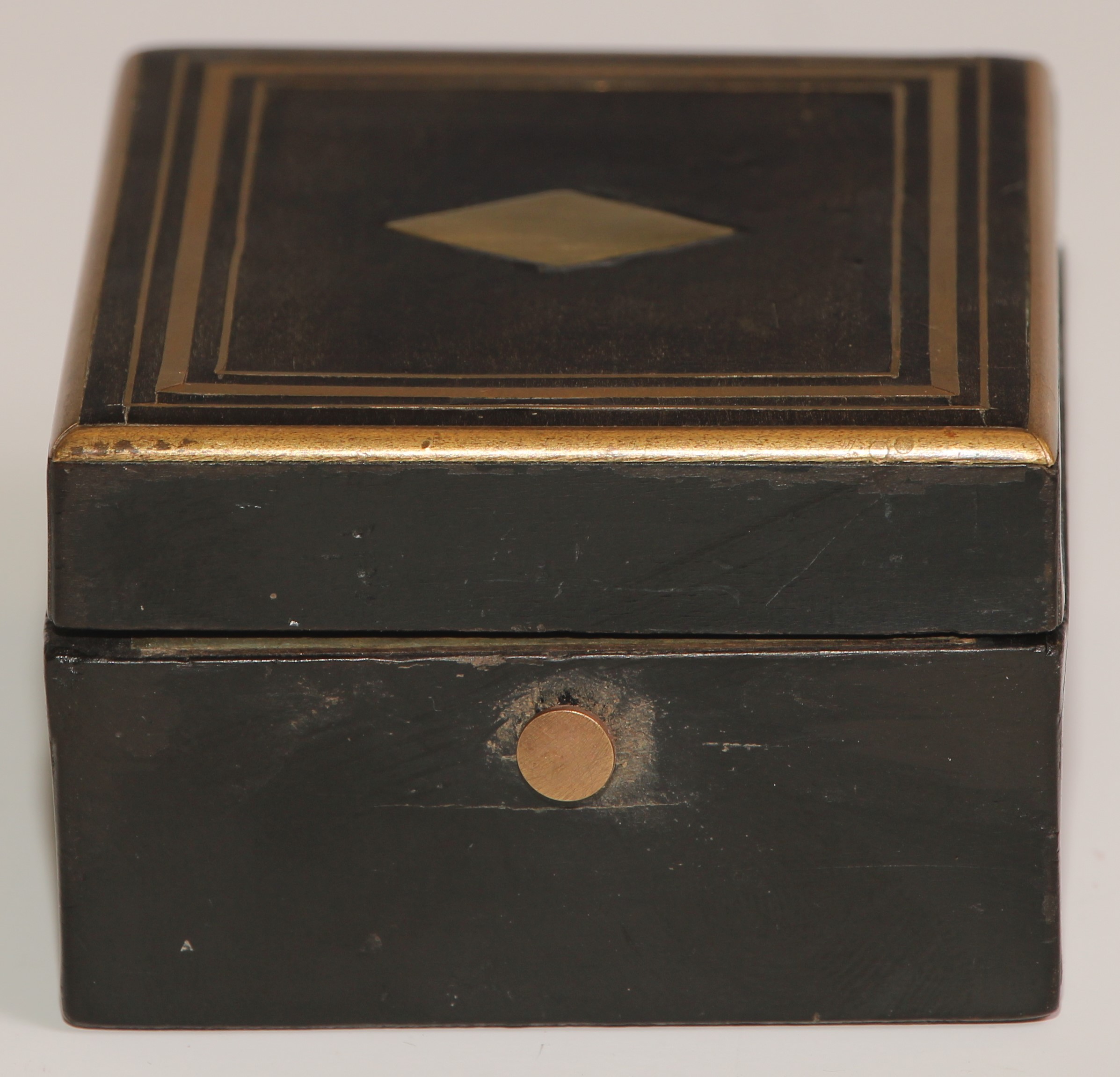 A 19th century French ebonised pocket watch box, hinged cover inlaid with a lozenge and outlined