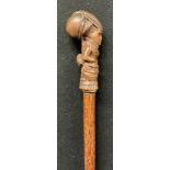 A 19th century French walking cane, the pommel carved as an aristocratic lady, palm wood shaft, 99cm