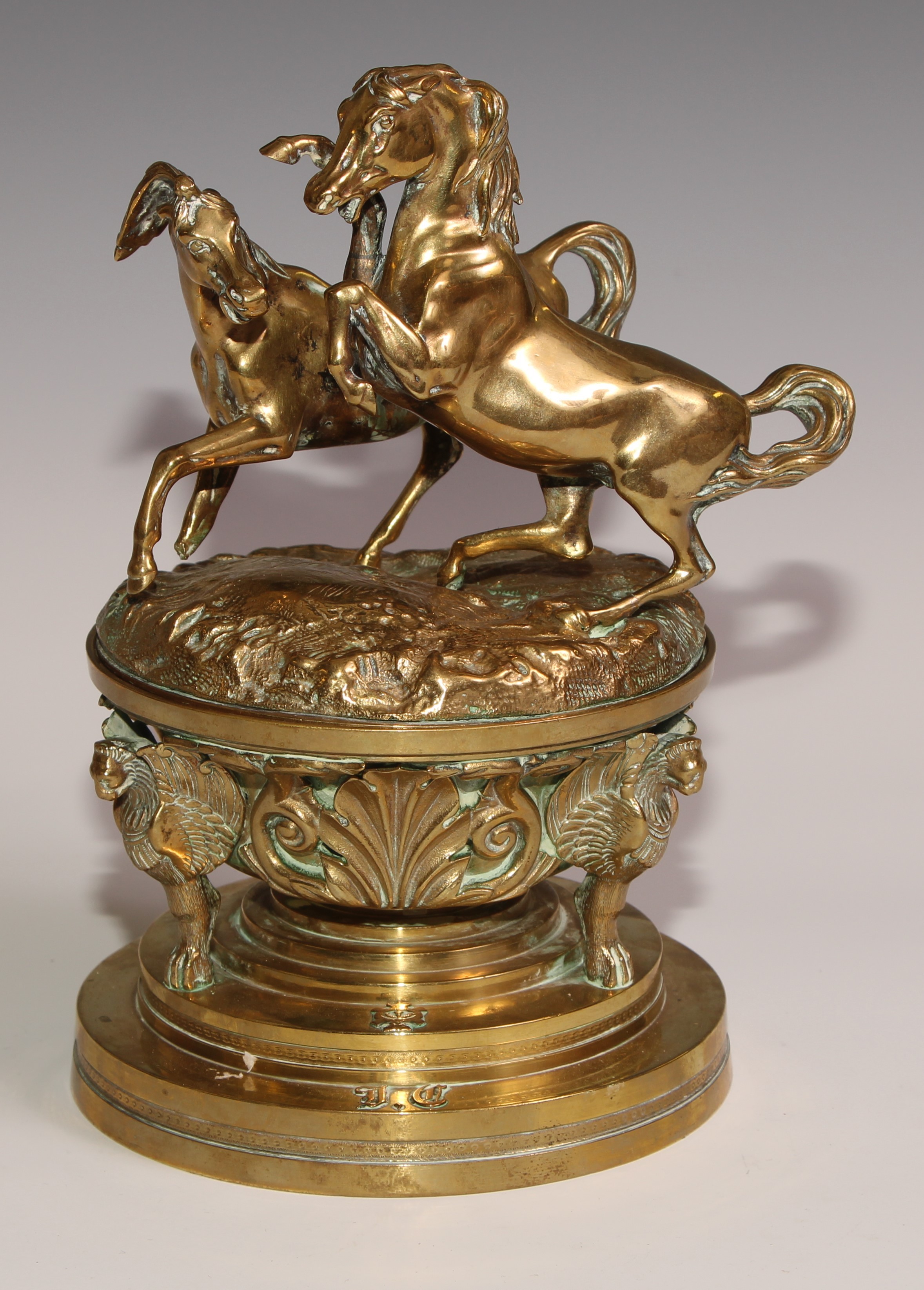 A substantial sculptural 19th century French bronze inkwell, the cover cast with a pair horses