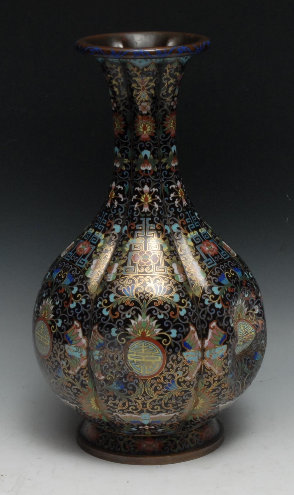 A Chinese cloisonne enamel fluted ovoid vase, decorated in polychrome with shou, butterflies,